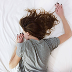 Woman lying on bed